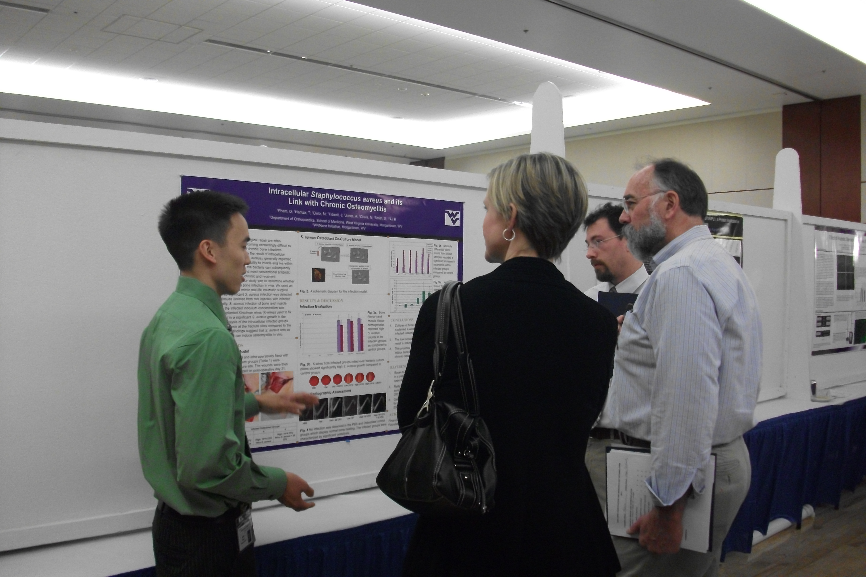 Danh Pham (MD student), standing with his poster, received the Second Place MD Poster Prize at the Van Liere Research Day