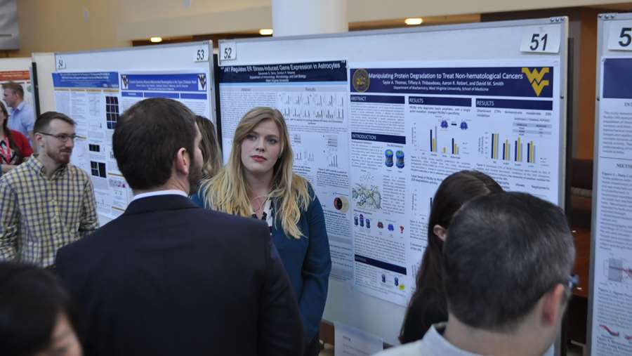 Taylor Thomas discussing her poster