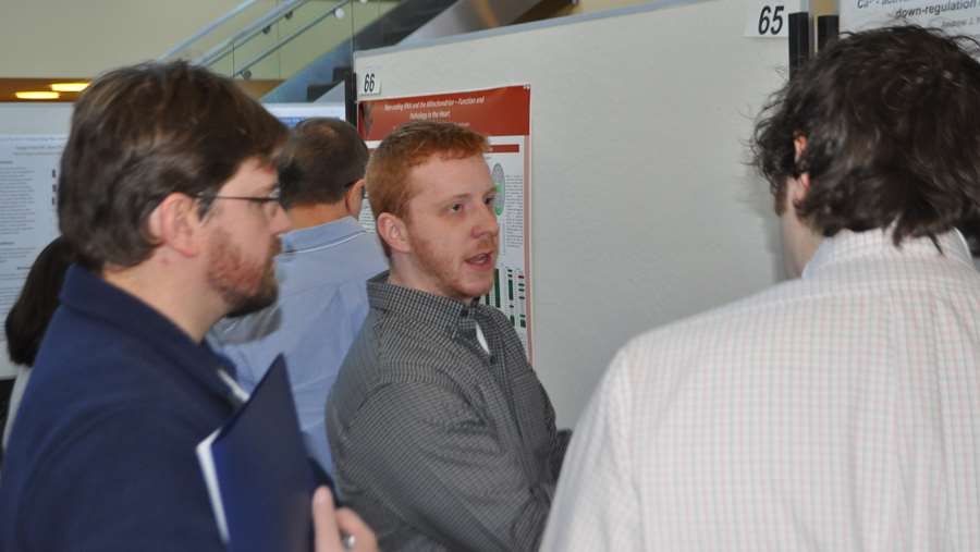 Drew Nickerson discussing his poster with the judges