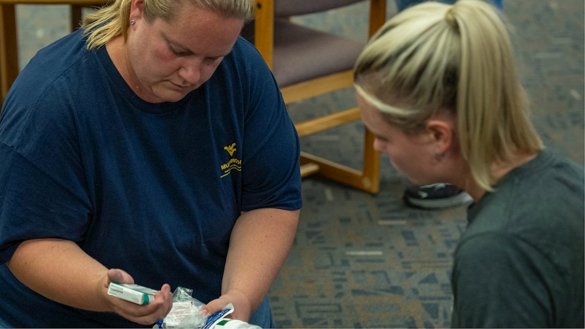 Dr. Sylwia Brooks, left, examines medical equipment with colleague