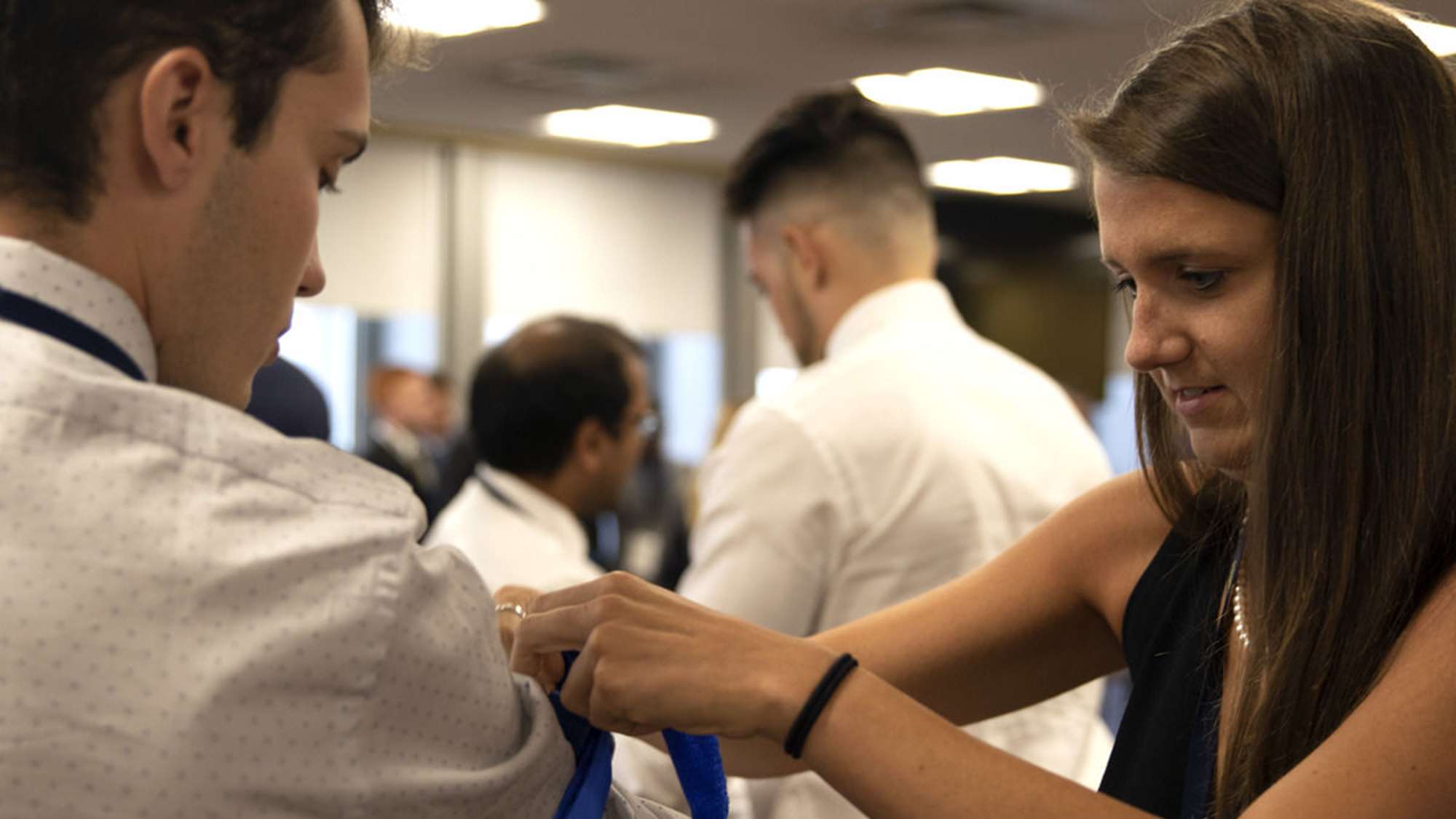 Woman teaching student to use tourniquet