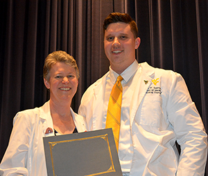 Cole Salmons (Class of 2020) receiving award from Dr. Anne Swisher