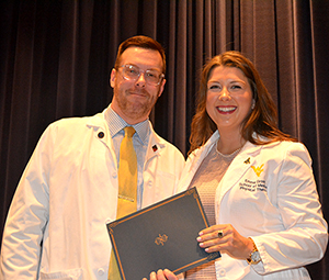 Emma Grose receiving award from Dr. Ralph Utzman