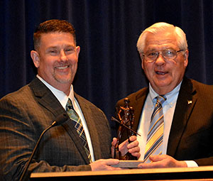 Scott Davis receiving Mary Lou Barnes Award for Distinguished Professional Service award from John Petros.
