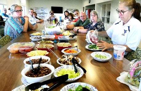 WVU Staff gathered around a table