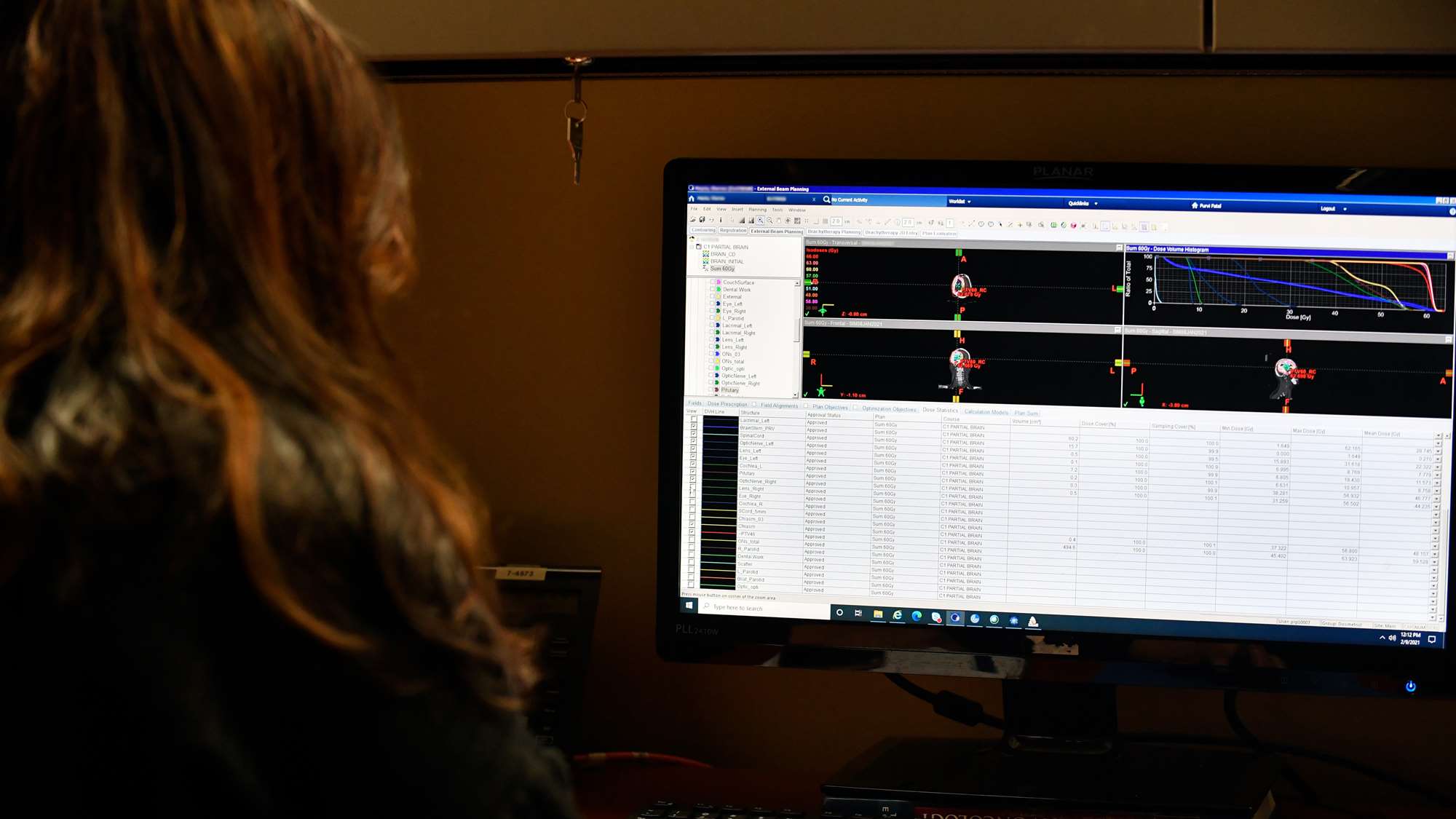 Female controls computer for targeted radiation treatment.