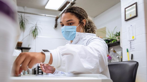 Female student works with lab equipment