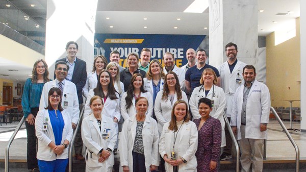 Group photo of division faculty, fellows and staff in Pylons Lobby