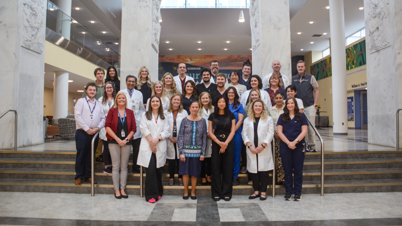 Group photo of division faculty, fellows and staff in Pylons Lobby