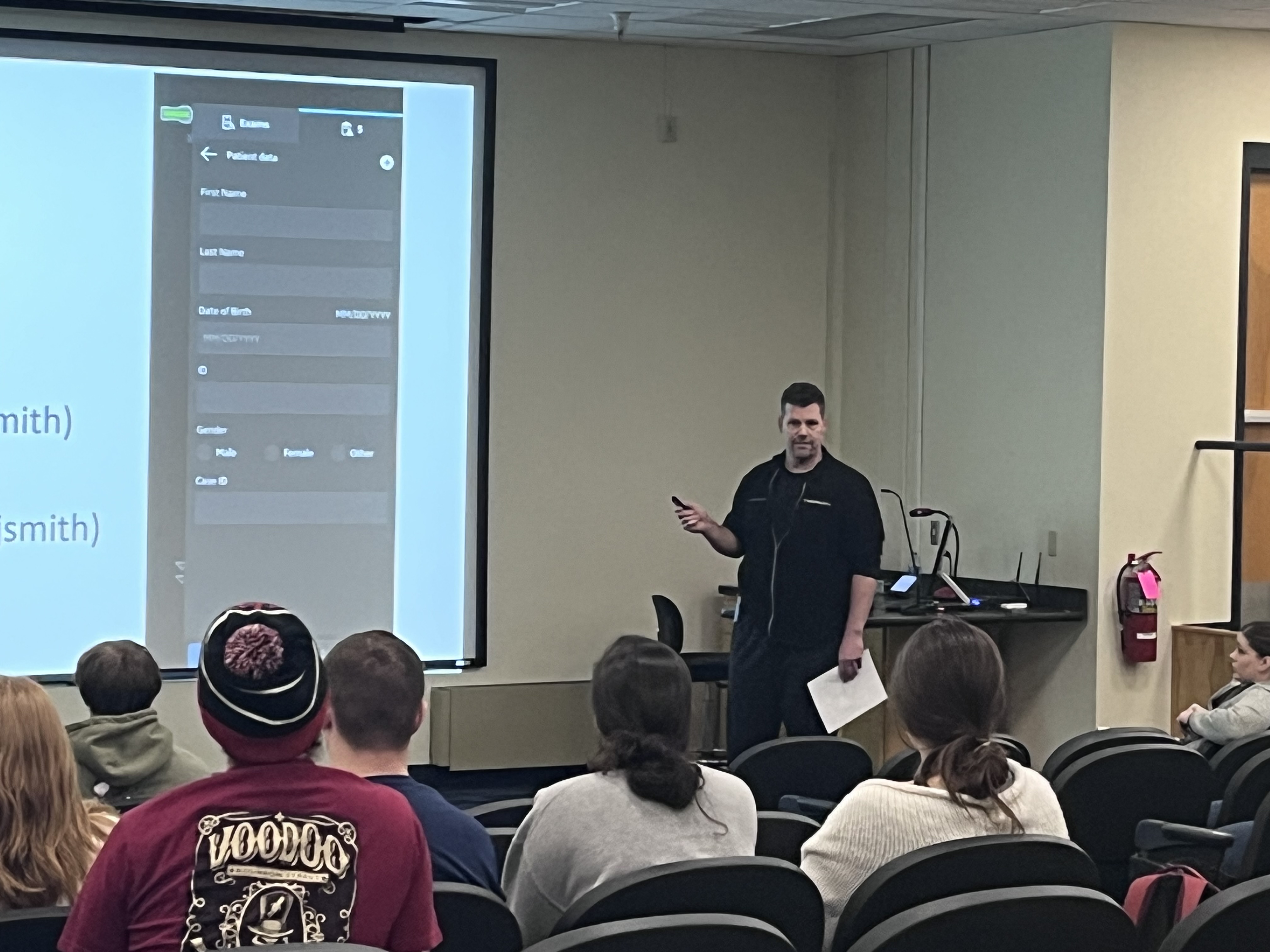 Faculty member lectures student in classroom