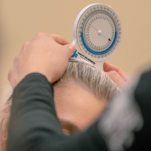 Physical therapist using an inclinometer