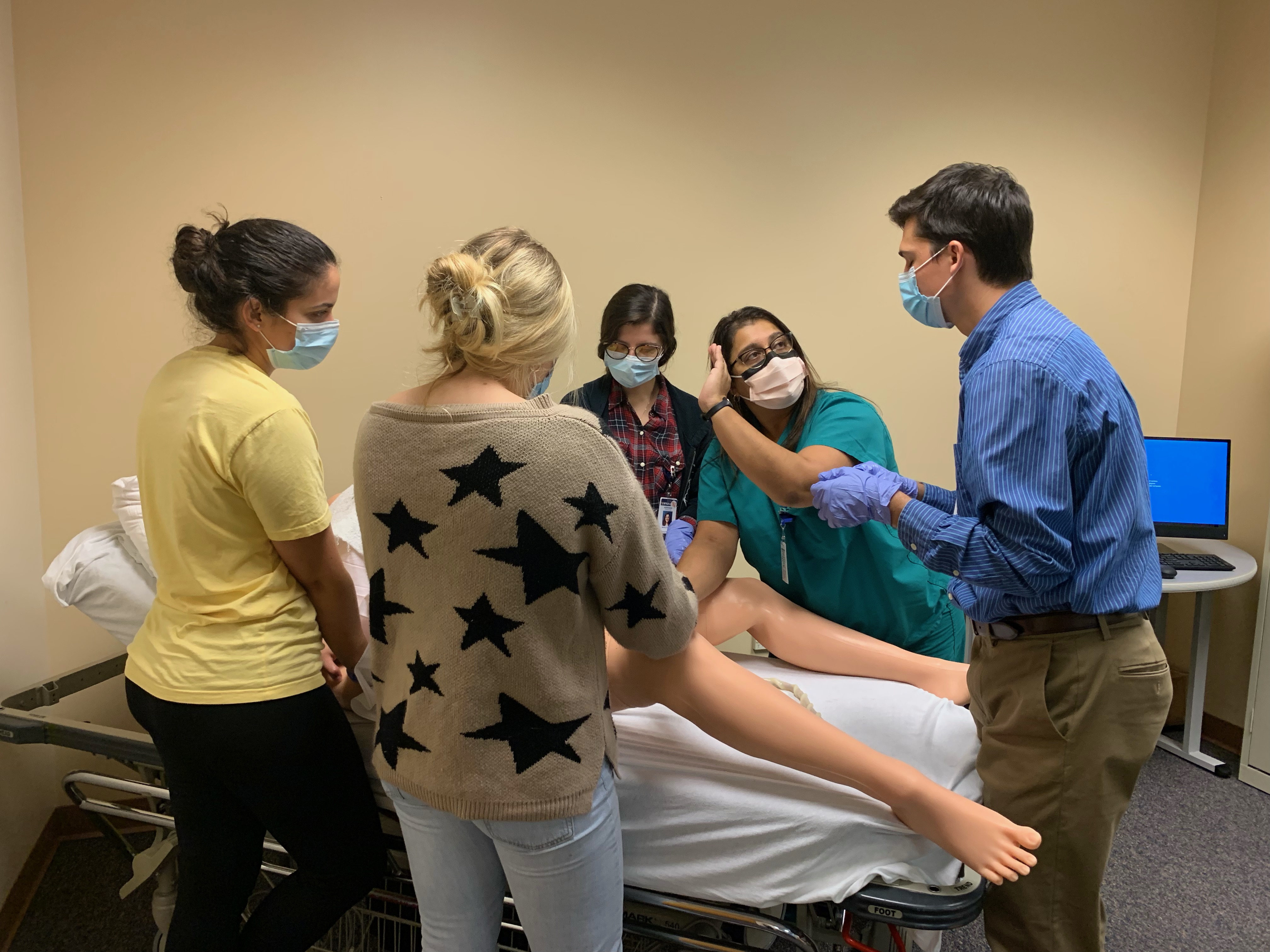 Students participate in a hands-on training session in the Birthing Simulation Lab