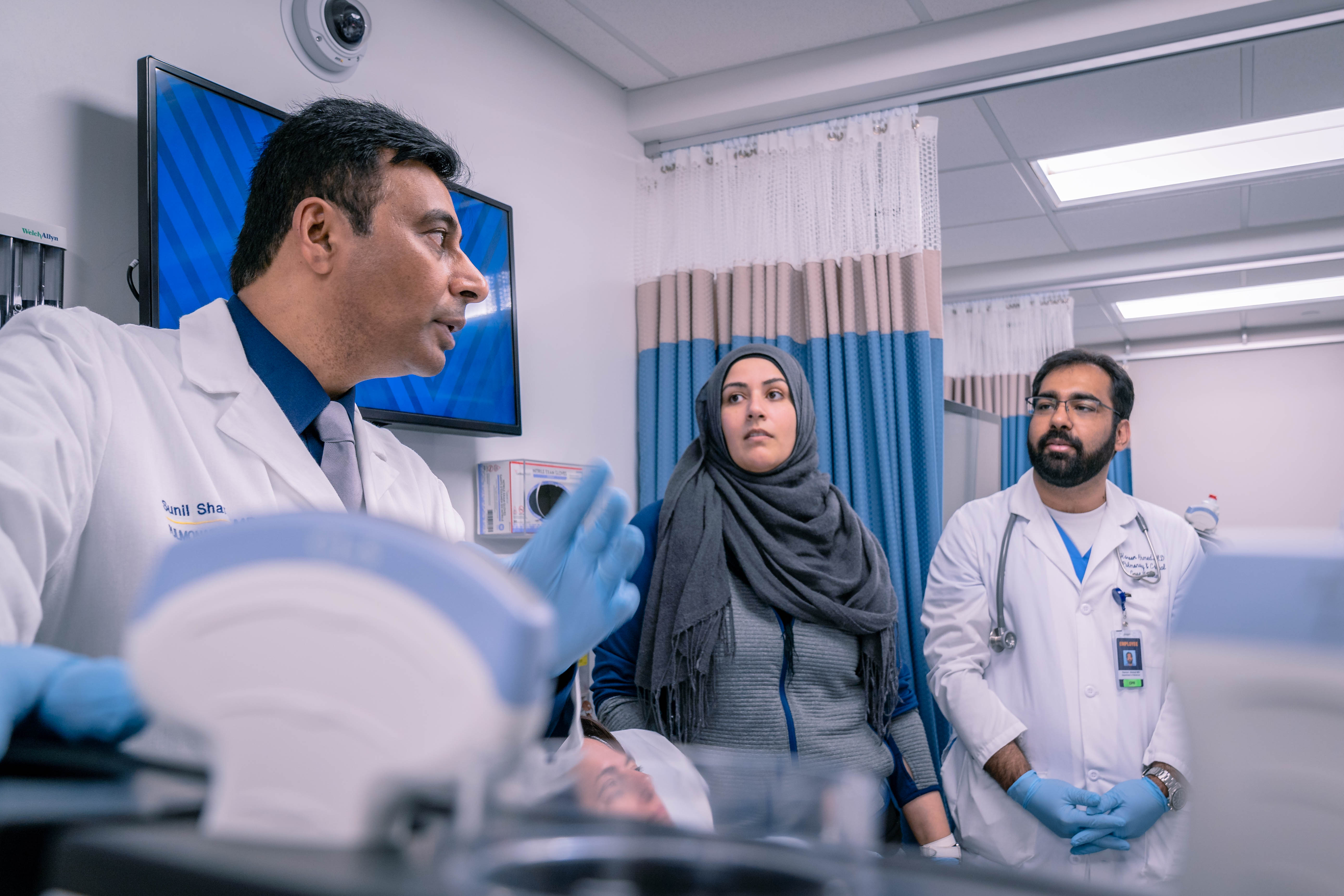 Dr. Sunil Sharma speaks with other medical professionals in the STEPS lab