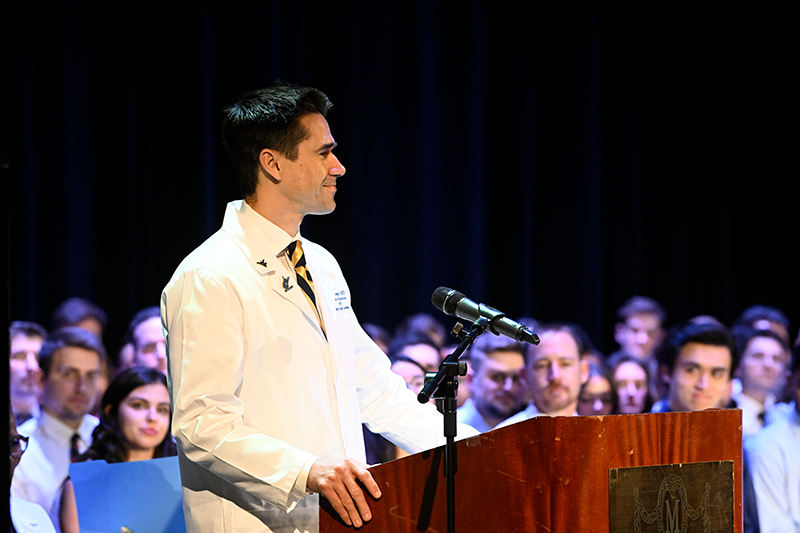 Marc Yester speaks at podium during White Coat Ceremony