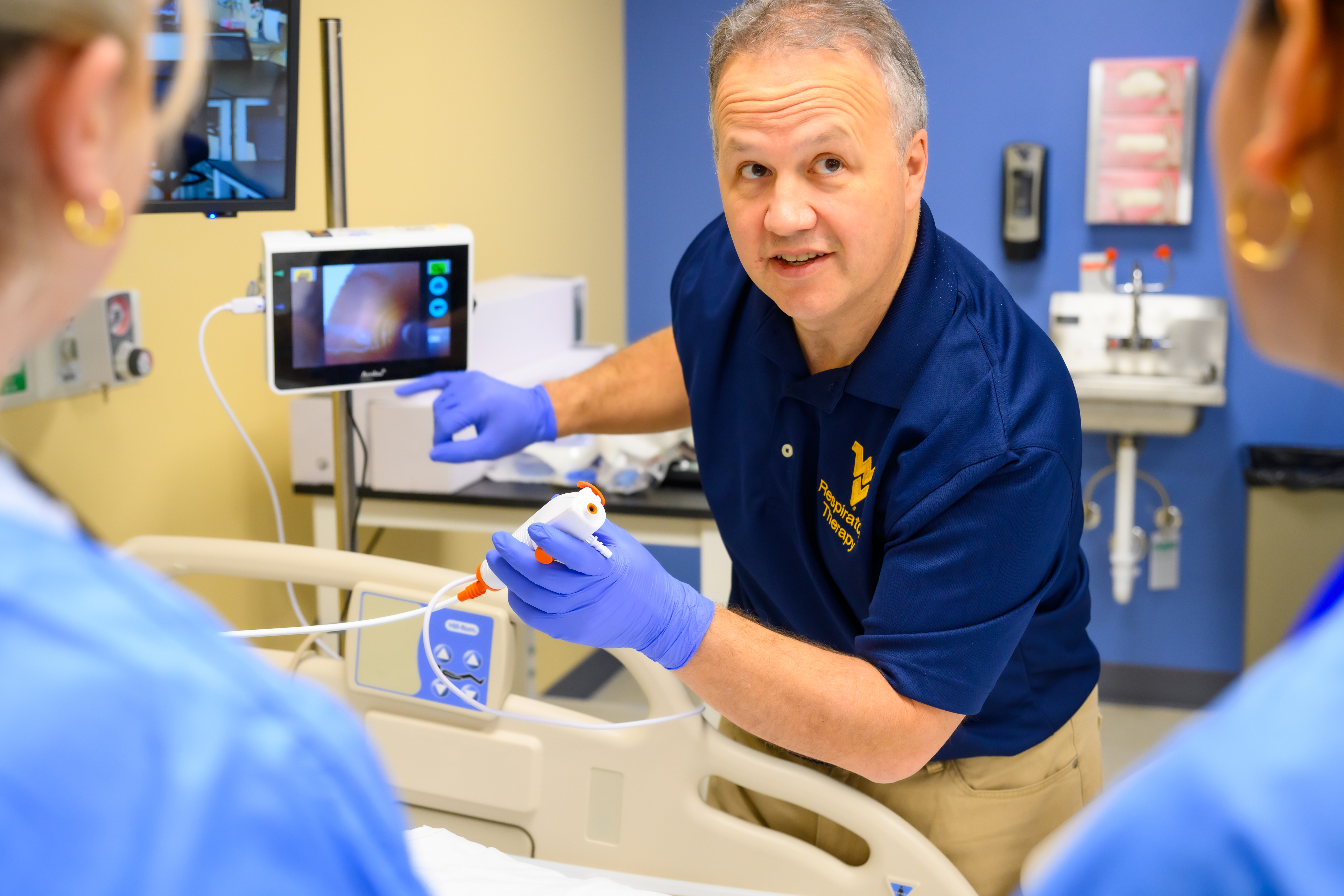 Program Director Michael Mehall demonstrates use of scope