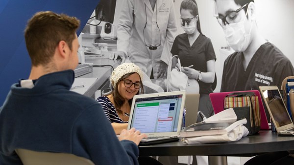Students working together on laptops in Health Sciences Center