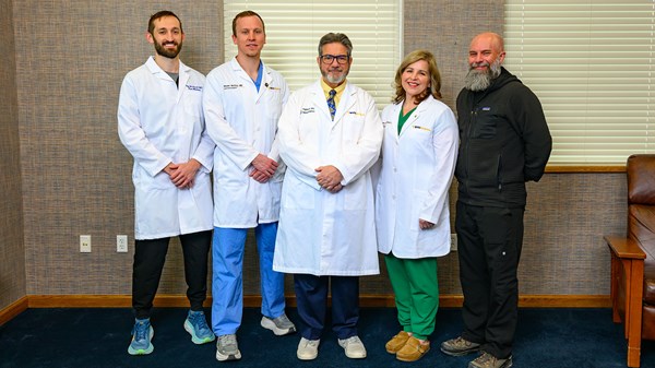 A picture of the pain fellowship faculty in a waiting area next to windows.