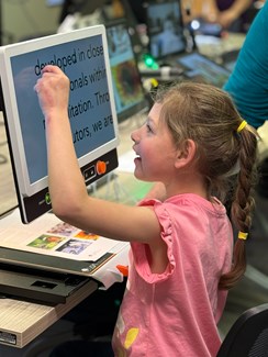 Photo of a CVRP student using an adaptive touch screen device
